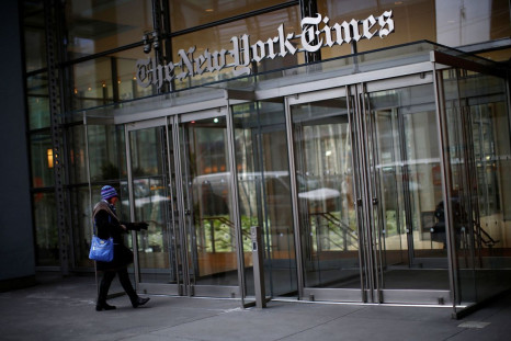A woman walks into the New York Times building in New York, February 7, 2013. 
