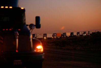 Trucks wait in a queue to cross into the United States in the Jeronimo-Santa Teresa International Bridge connecting the city of Ciudad Juarez to Santa Teresa, Nuevo Mexico, after Texas Governor, Greg Abbott announced that traffic commercial trucks from Ch
