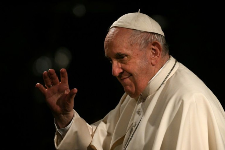 Pope Francis waves as he presides over the 'Way of The Cross' service at the Colosseum monument in Rome