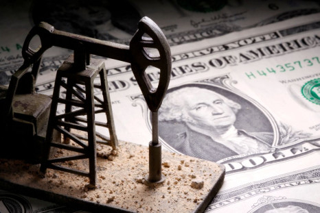 A 3D-printed oil pump jack is placed on dollar banknotes in this illustration picture, April 14, 2020. 