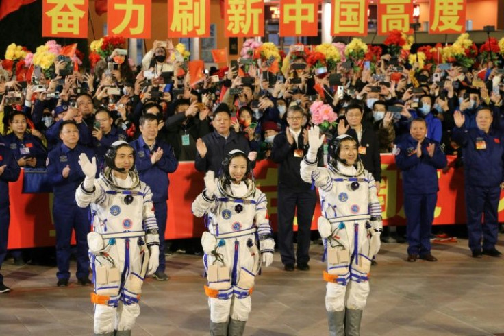 Astronauts Ye Guangfu, Wang Yaping and Zhai Zhigang, wave at a departure ceremony before their launch on the Shenzhou 13 spacecraft in October 2021
