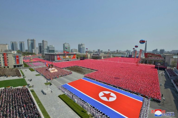 Photographs released by North Korea's state news agency showed thousands of colourfully dressed people marching through Pyongyang's Kim Il Sung Square