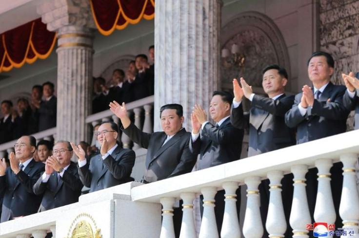 North Korean leader Kim Jong Un waved at the marchers from a balcony