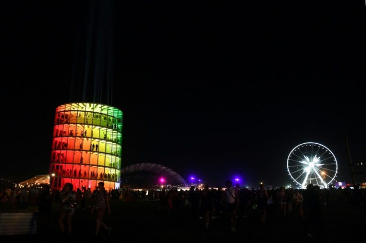 Spectra, a seven-story spiral walkway up to a viewing deck, and the ferris wheel are seen at night at the Coachella Valley Music and Arts Festival in Indio, California, on April 15, 2022