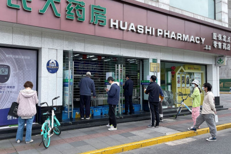 People wait outside a pharmacy to buy products, as the city eases the lockdown in some areas, amid the coronavirus disease (COVID-19) outbreak in Shanghai, China April 16, 2022. 