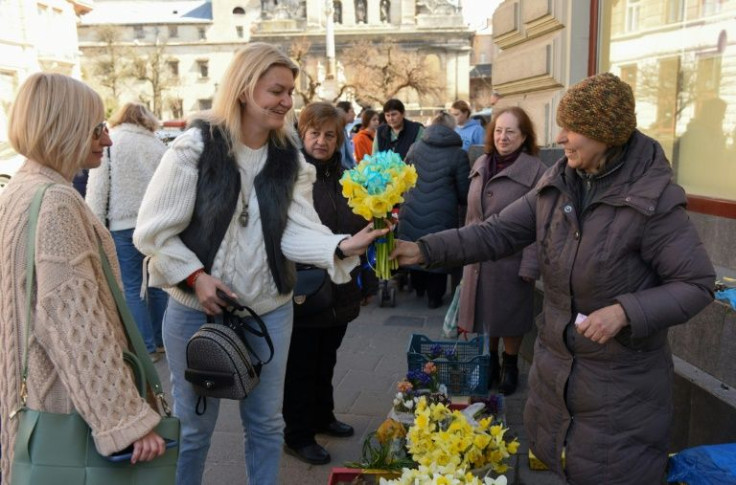 Olga Fityo-Styslo sells two kinds of daffodils at the flower market -- one their natural colour, the other tinted after feeding off a mixture of water and navy-blue ink