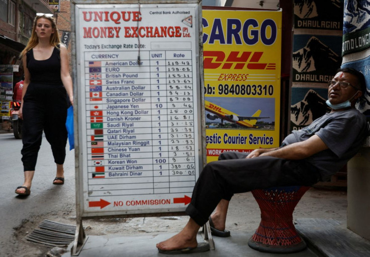 A man sits outside a money exchange at Thamel, a major tourist hub, as government tightens imports of cars, gold and cosmetics after the foreign exchange reserves have fallen in Kathmandu, Nepal April 12, 2022.