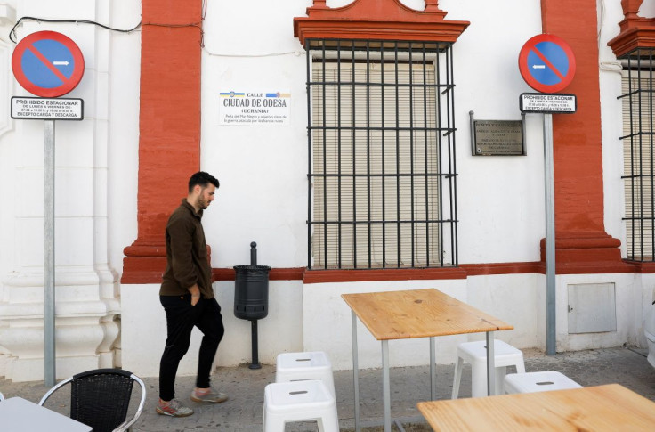 A man walks past a street sign that reads 'City of Odesa' street after it was changed from the original name, as other street names were also changed to include names of Ukrainian cities in support of Ukraine, amid Russia's invasion, in the town of Fuente