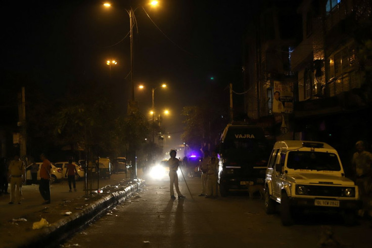 Police personnel stand guard after clashes broke out during a Hindu religious procession in Jahangirpuri area of New Delhi, India, April 16, 2022. 