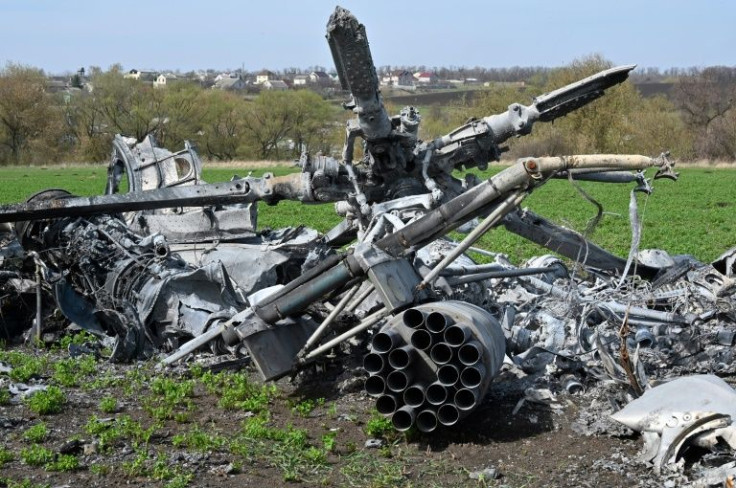 The wreckage of a downed Russian helicopter lies in a field near Kharkiv on April 16, 2022