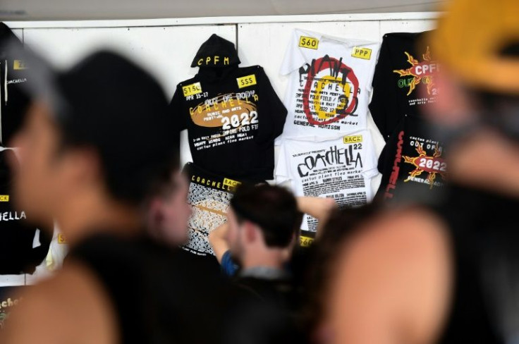 People wait in line at a merchandise stand at the Coachella Valley Music and Arts Festival in Indio, California