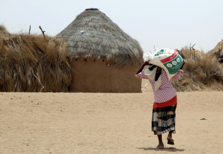 The Yemen war has displaced millions, including this resident receiving food aid at a camp in Hodeida province