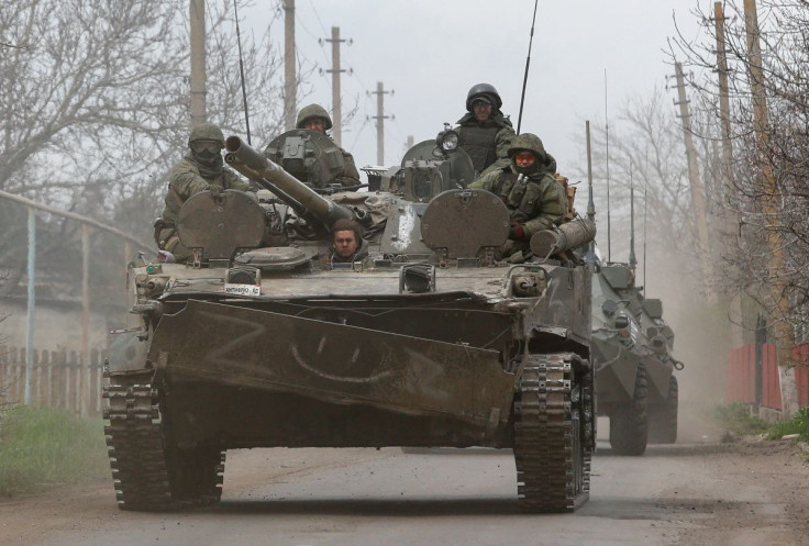 Service members of pro-Russian troops sit atop of an armoured vehicle during Ukraine-Russia conflict near the southern port city of Mariupol, Ukraine April 17, 2022. 