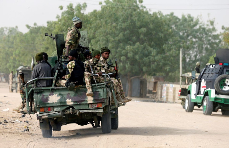 Nigerian military ride on their truck as they secure the area where a man was killed by suspected militants during an attack around Polo area of Maiduguri, Nigeria February 16, 2019. 