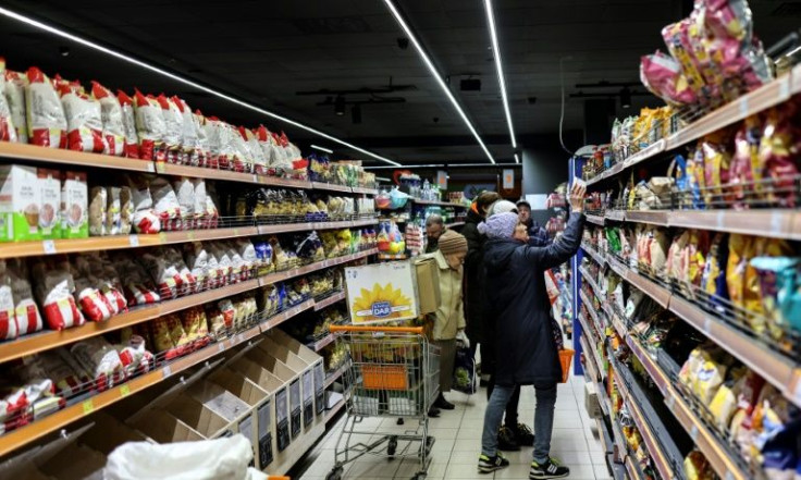 Some aisles are bare, but many customers search for essentials such as bread, meat, vegetables, cheese and tea