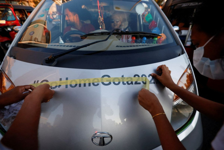 Demonstrators apply a sticker on a passing car during a protest against Sri Lankan President Gotabaya Rajapaksa, near the Presidential Secretariat, amid the country's economic crisis, in Colombo, Sri Lanka, April 16, 2022. 