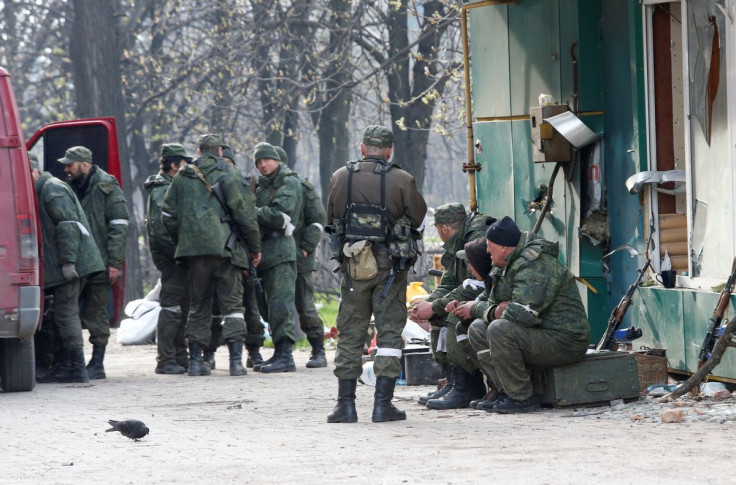 Service members of pro-Russian troops gather in a street during Ukraine-Russia conflict in the southern port city of Mariupol, Ukraine April 17, 2022. 