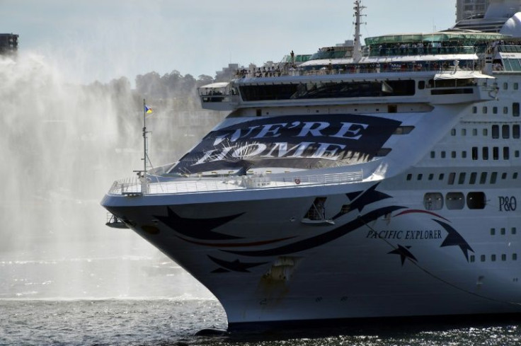 The Pacific Explorer made a dramatic entrance with a large banner that read "We're home" draped across its bow