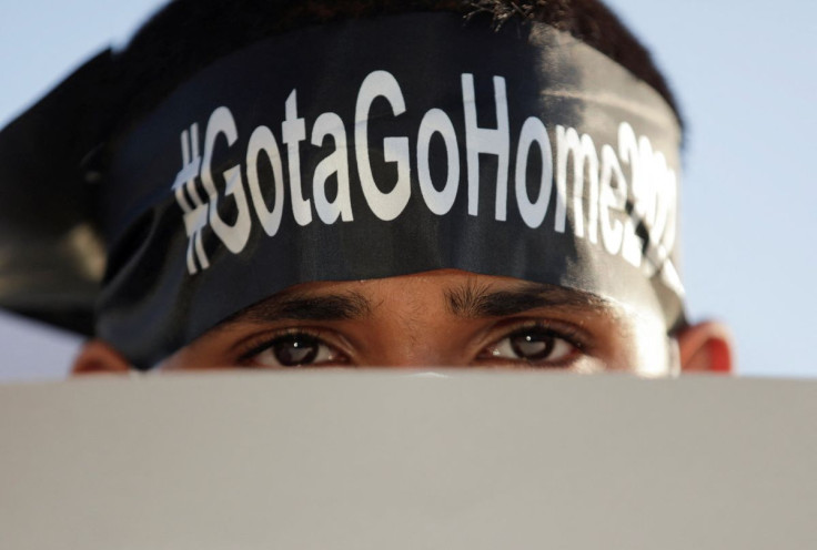 A demonstrator holding a placard takes part in a protest against the Sri Lanka President Gotabaya Rajapaksa near the Presidential Secretariat, amid the country's economic crisis in Colombo, Sri Lanka, April 15, 2022.