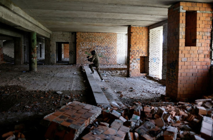 A member of the territorial defence force attends a training simulation for raiding a building occupied by enemy forces as they prepare for new assault, amid Russiaâs invasion of Ukraine, at an abandoned building in Sumy, Ukraine April 15, 2022. 