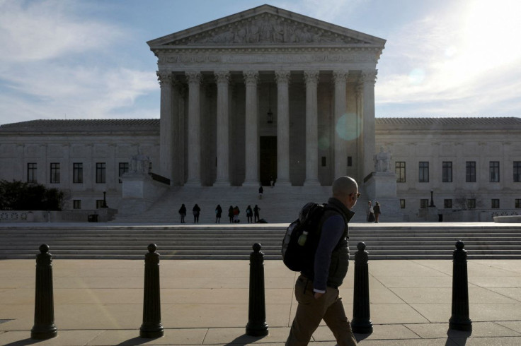 A pedestrian walks by the U.S. Supreme Court building in Washington, U.S. March 15, 2022. 