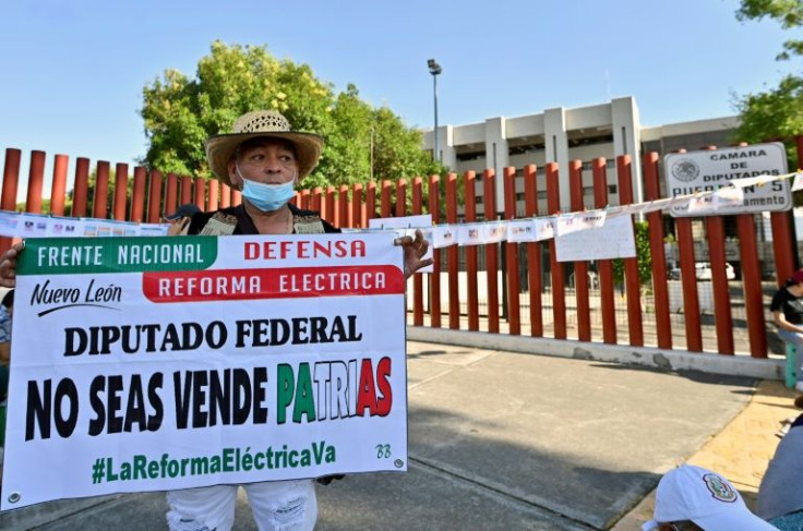 'Don't sell out the nation' reads a sign held by a supporter of Mexican President Andres Manuel Lopez Obrador at a rally in favour of proposed electricity sector reforms outside Congress