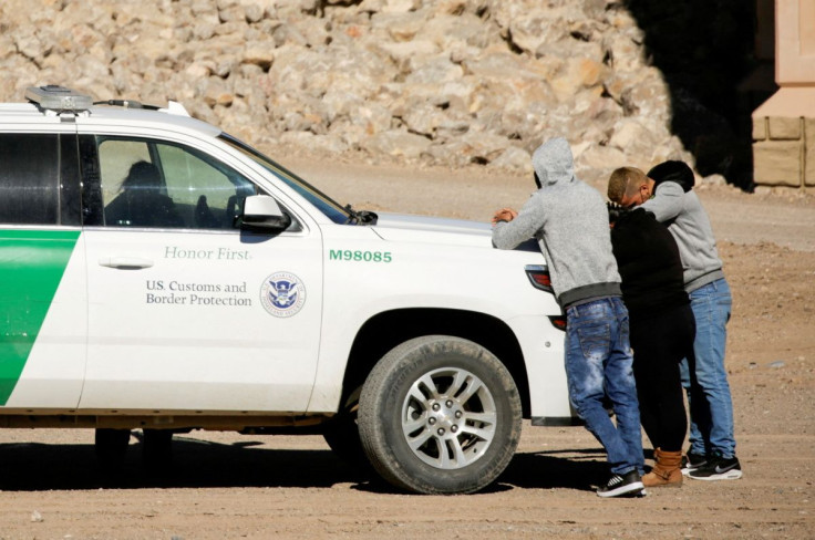 Cuban migrants are detained by a U.S. Border Patrol agent as they turn themselves in to request asylum, after crossing into El Paso, Texas, U.S., as seen from Ciudad Juarez, Mexico February 5, 2021.