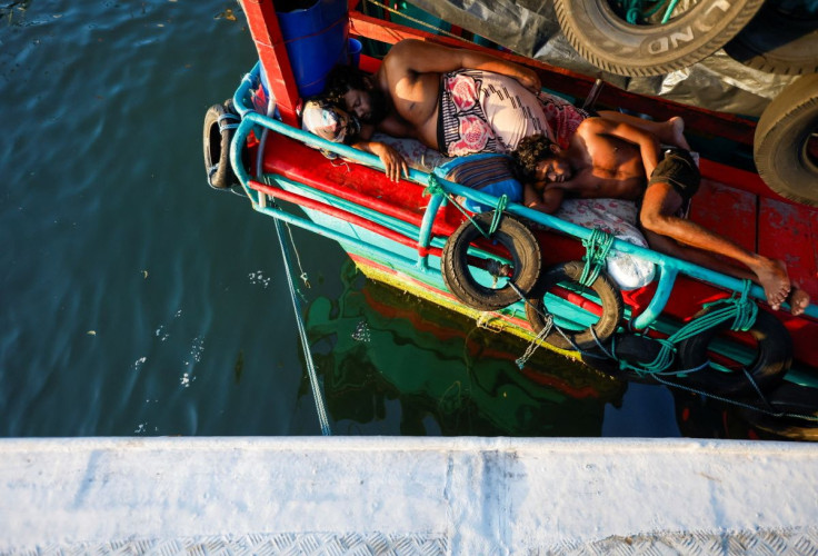 Men sleep on a fishing trawler parked at Negombo's "Lellama" fishery harbour, as fishermen and their families struggle due to a lack of diesel and a price hike over the last few months amid the country's economic crisis, in Negombo, Sri Lanka, April 16, 2