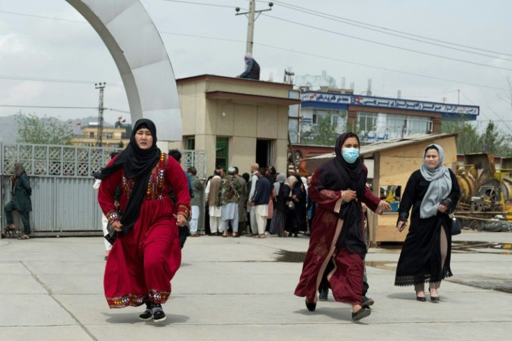 Relatives of victims arrive to search for their loved ones outside a hospital in Kabul