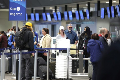 United Airlines passengers check in for flights at San Francisco International Airport on April 19, 2022