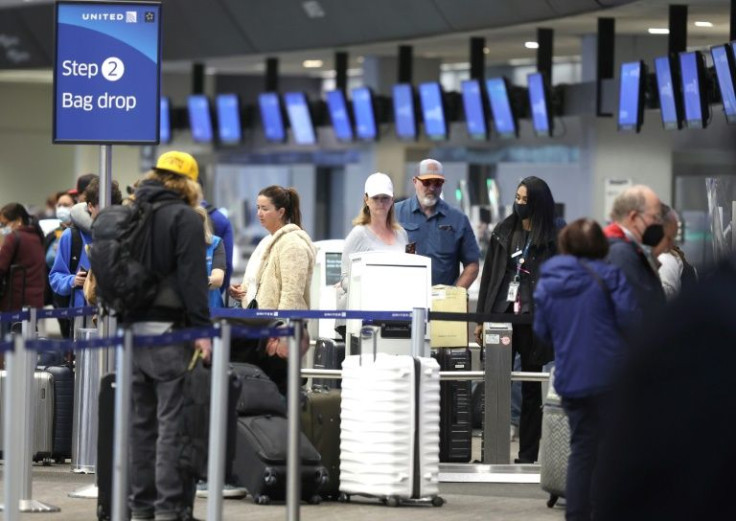 United Airlines passengers check in for flights at San Francisco International Airport on April 19, 2022
