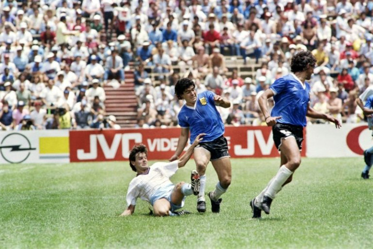 Diego Maradona (center) battles English midfielder Steve Hodge (on the ground) on June 22, 1986 during the World Cup quarterfinal in Mexico City won by Argentina against England