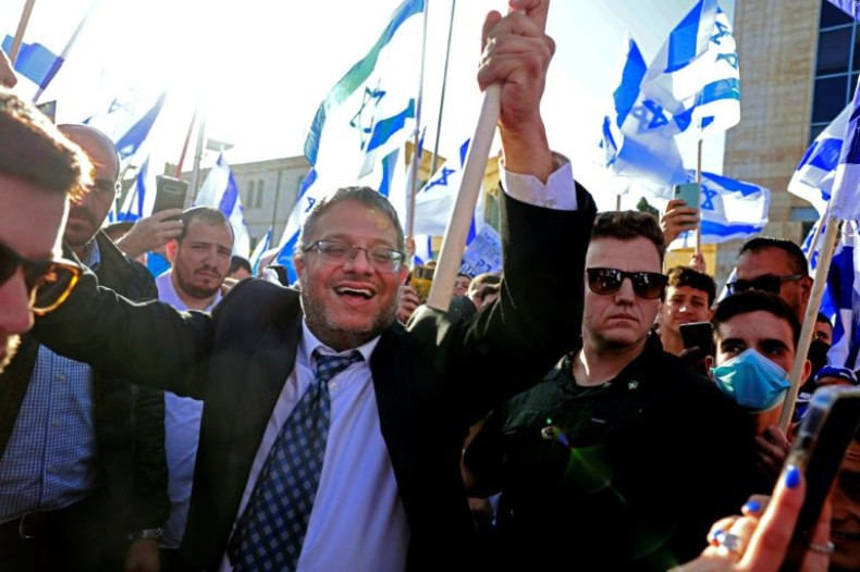 Israeli far-right lawmaker Itamar Ben Gvir, raises an Israeli flag in Jerusalem on April 20