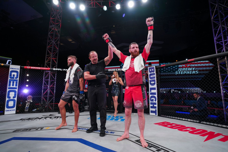 Clay Collard raises his hands after winning over Jeremy Stephens