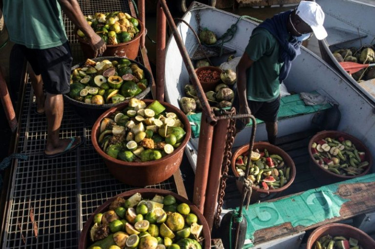 Workers with Humane Society International load their boats twice a day with food for the chimps