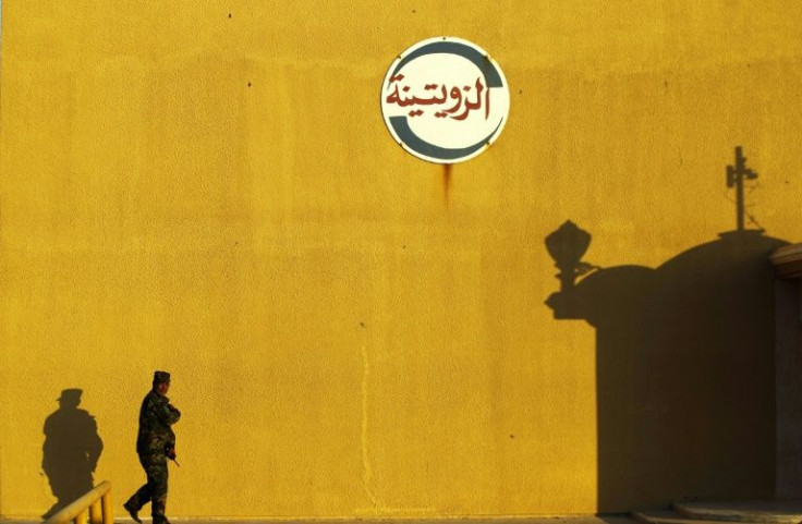 A member of forces opposed to Libya's unity government walks at the Zueitina oil terminal