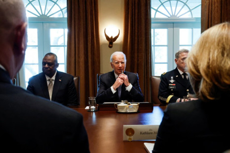 U.S. President Joe Biden is flanked by U.S. Defense Secretary Lloyd Austin and Chairman of the Joint Chiefs of Staff General Mark Milley as he meets with military leaders in the Cabinet Room at the White House in Washington, U.S., April 20, 2022. 