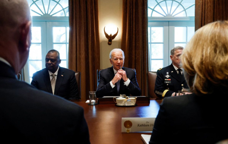 U.S. President Joe Biden is flanked by U.S. Defense Secretary Lloyd Austin and Chairman of the Joint Chiefs of Staff General Mark Milley as he meets with military leaders in the Cabinet Room at the White House in Washington, U.S., April 20, 2022. 
