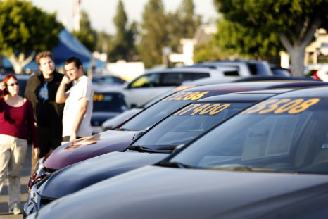People look at vehicles for sale on the lot at AutoNation dealership in Cerritos, California December 9, 2015.   
