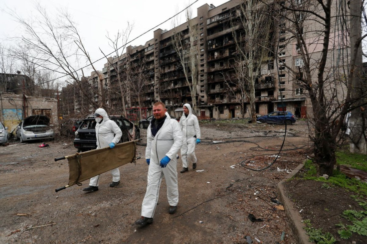 Emergency management specialists search for the bodies of people killed during Ukraine-Russia conflict in the southern port city of Mariupol, Ukraine April 21, 2022.