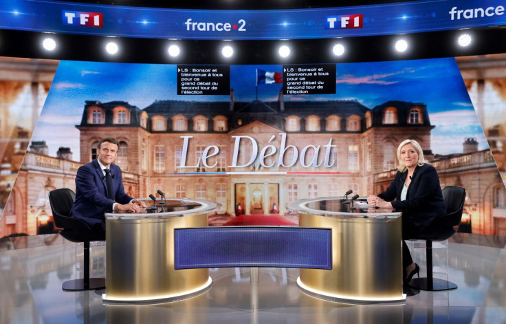 French President Emmanuel Macron, candidate for his re-election, and French far-right Rassemblement National party presidential candidate Marine Le Pen pose prior to taking part in a French presidential election debate, in Saint-Denis, north of Paris, Fra