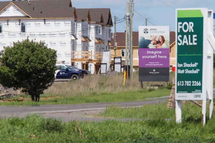 Real estate signs stand in front of new homes being constructed in Ottawa, Ontario, Canada, May 27, 2021.  