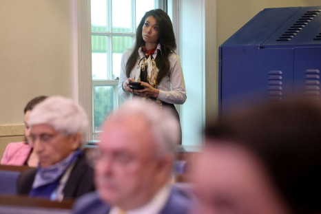 Chanel Rion of the One America News Network (OANN) continues to disregard the coronavirus safety guidelines put out by the White House Correspondents Association by standing in an aisle without an assigned seat in the White House press briefing room as U.