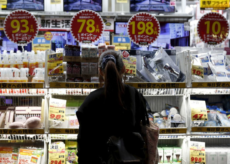 A woman looks at items outside an outlet store at a shopping district in Tokyo, Japan, February 25, 2016.