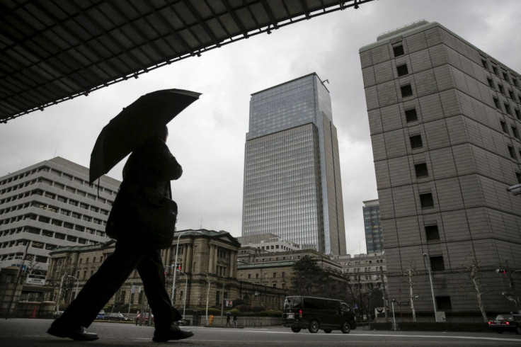  A businessman walks near the Bank of Japan headquarters in Tokyo, Japan, Feb. 15, 2016. 