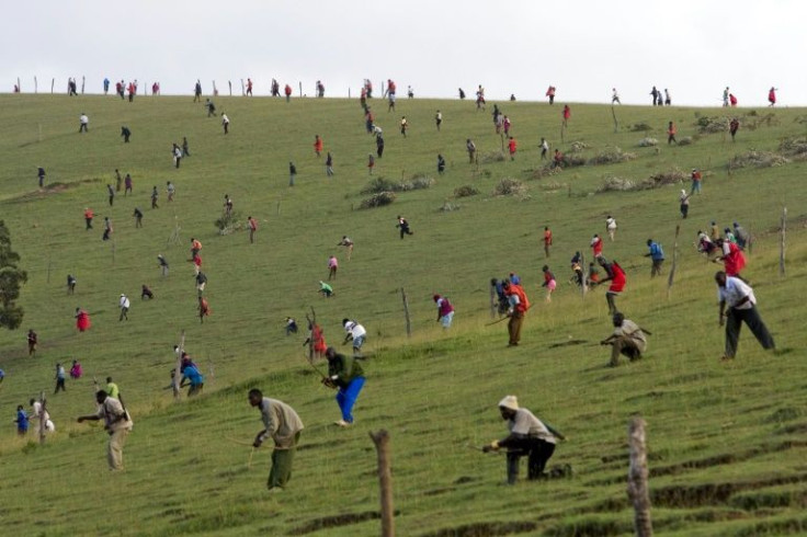Maasai warriors bearing bows and arrows clash with members of the Kalenjin tribe in post-election violence in March 2008