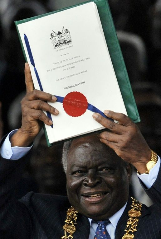 Charter: Kibaki holds aloft Kenya's new constitution at a ceremony in Nairobi in August 2010