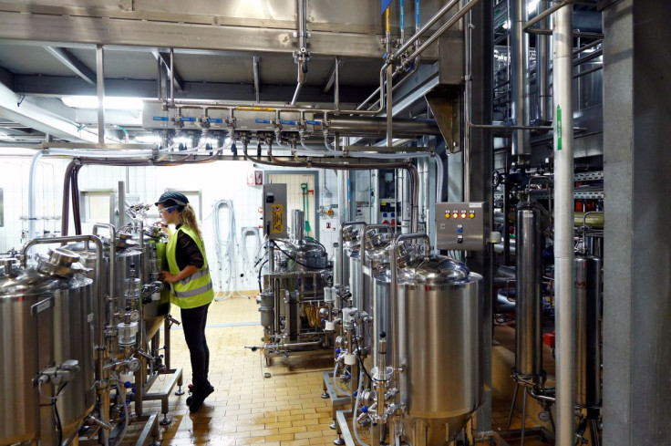 A worker checks beer quality at Anheuser-Busch InBev brewery in Leuven, Belgium November 25, 2019. Picture taken November 25, 2019.  