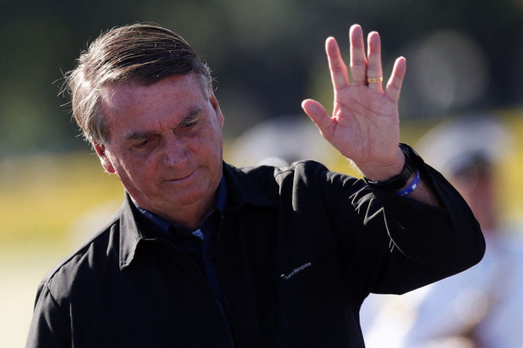 Brazil's President Jair Bolsonaro waves during a national flag hoisting ceremony in honour of the Diplomat's Day at the Alvorada Palace in Brasilia, Brazil, April 20, 2022.