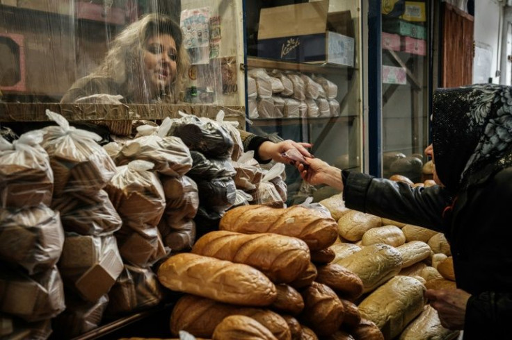Tatyana Ivanenko, 45, sells bread, and says she is determined to feed her town until the very end